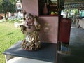 A standing old porcelain Buddha statue of Budai at the corridor entrance of the home