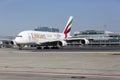 A standing plane of Emirates Airline on a runway