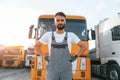 Standing and posing for the camera. Man in unifrom doing service for big truck vehicle Royalty Free Stock Photo