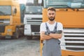 Standing and posing for the camera. Man in unifrom doing service for big truck vehicle Royalty Free Stock Photo