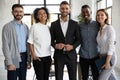 Standing in row smiling diverse team looking at camera. Royalty Free Stock Photo