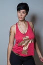 Standing short-hair brunette woman, wearing a red tank top with Royalty Free Stock Photo