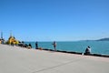 Standing and sitting men fishing at Black Sea with poles Batumi port Georgia Royalty Free Stock Photo