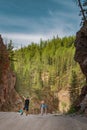 Standing sporty man with backpack on the mountain peak and beautiful mountains atbright sunny day. Royalty Free Stock Photo