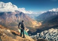 Standing sporty man with backpack on the mountain peak Royalty Free Stock Photo