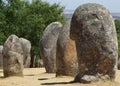 Standing stone megaliths in rows at neolithic site, casting shadows with copy space.