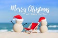 Sandy Christmas Snowmen are celebrating Christmas Holidays on a beautiful beach Royalty Free Stock Photo