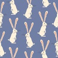 Standing white rabbit with long ears. Adorable hare on a blue background easter seamless pattern. Royalty Free Stock Photo