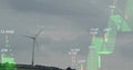 Standing wind turbine on rural hillside, with candlestick chart numeric points overlay, copy space Royalty Free Stock Photo