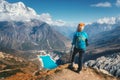 Standing woman with backpack on the mountain peak Royalty Free Stock Photo