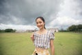 Standing woman holding sunglasses and smiling happy at the park. Royalty Free Stock Photo