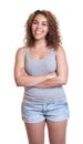 Standing woman from Venezuela with crossed arms and hot pants Royalty Free Stock Photo