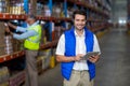 Standing worker smiling at camera while holding digital tablet Royalty Free Stock Photo