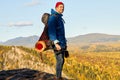 Standing young man with backpack on the mountain peak Royalty Free Stock Photo