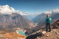 Standing young woman on the mountain peak against lake Royalty Free Stock Photo