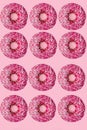 Standout donut. 12 pink donuts. flat lay. pink background