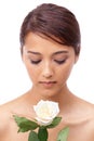 She stands out like a single white rose. A beautiiful, young woman smelling a white rose. Royalty Free Stock Photo