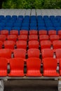 stands of a small stadium with rows of white, blue and red seats Royalty Free Stock Photo