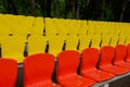 stands of a small stadium with rows of yellow and red seats Royalty Free Stock Photo