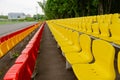 Stands of a stadium with yellow and red seats Royalty Free Stock Photo