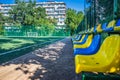 Stands on the soccer field with artificial green grass near the school. Amateur football field. Sunny summer day Royalty Free Stock Photo