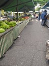 Stands of vegetables and people shopping in an open market, feira livre, in Sao Paulo, Brazil.