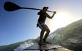 Standup paddle board surfing a wave at sunrise Royalty Free Stock Photo