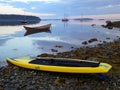 Standup paddleboard and schooners in the beach of Northwest Harbor in Maine early in the morning Royalty Free Stock Photo