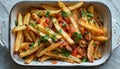 A staple food dish made with french fries and tomatoes in a white casserole dish Royalty Free Stock Photo