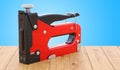 Staple gun on the wooden table. 3D rendering