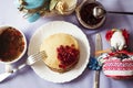 Staple of yeast pancakes, traditional for Russian pancake week. Stack of wheat golden pancakes or pancake cake with freshly picked