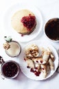 Staple of yeast pancakes, traditional for Russian pancake week. Stack of wheat golden pancakes or pancake cake with freshly picked