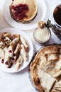 Staple of yeast pancakes, traditional for Russian pancake week. Stack of wheat golden pancakes or pancake cake with freshly picked