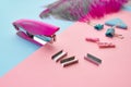 Stapler and clips closeup, blue background Royalty Free Stock Photo