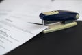 a stapler and the documents files in office on the table, staple the paper sheets of resume and contracts Royalty Free Stock Photo