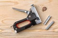 Stapler gun on a wooden plane with staples Royalty Free Stock Photo