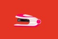 Stapler on a red background Royalty Free Stock Photo