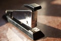 Stapler in silver and black on marble slab