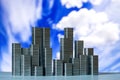 Staples arranged to form city skyline on a blue sky with white c Royalty Free Stock Photo