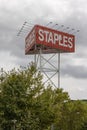 Staples sign standing tall against cloudy sky Royalty Free Stock Photo