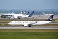 Star Alliance airplane takes off in front of other planes parked on Munich Airport Royalty Free Stock Photo