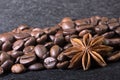 Star anise, on the background of coffee with beautiful highlights on the surface of grains Royalty Free Stock Photo