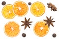 Star anise, black pepper, cinnamon, dried oranges and an apple on a white background.