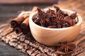 Star anise and cinnamon stick on wooden background Royalty Free Stock Photo