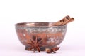 Star anise,cinnamon stick and a bowl Royalty Free Stock Photo