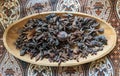 Star anise and dried nutmeg on a wooden plate can be utilized as interior design elements that create an exotic and warm ambiance. Royalty Free Stock Photo