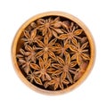 Star anise fruits and seeds, pericarps of Illicium verum, in wooden bowl