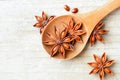 Star anise fruits in the wooden spoon, on the board, top view Royalty Free Stock Photo