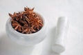Star anise in a mortar and pestle is ready to be crushed. Grinding of spices. Close up. Copy space Royalty Free Stock Photo