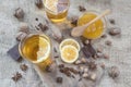 Star anise, orange frut sliced, cinnamon, jar of honey, nuts and cloves on wooden table.